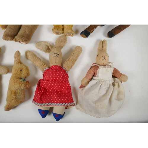 297 - A collection of vintage plush toys, including a Bambi deer, three rabbits and four antique teddy bea... 