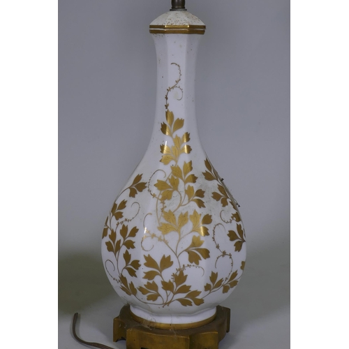 37 - A pair of vintage French Paris porcelain table lamps with gilded decoration, mounted on ormolu bases