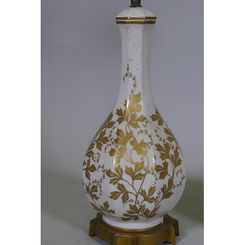 37 - A pair of vintage French Paris porcelain table lamps with gilded decoration, mounted on ormolu bases