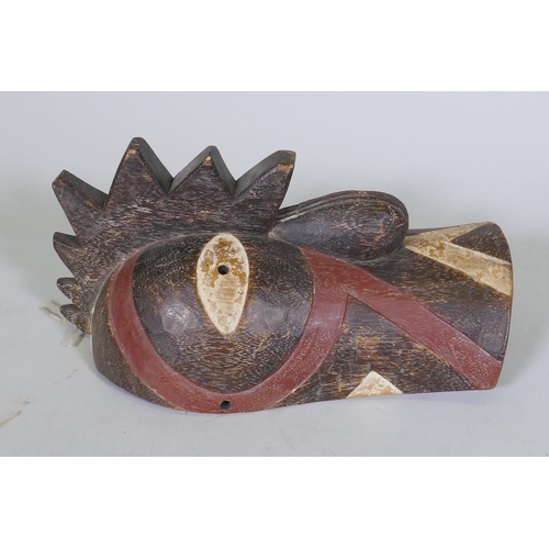 47 - An African tribal carved and painted wood mask in the form of a cockerel, 36cm long