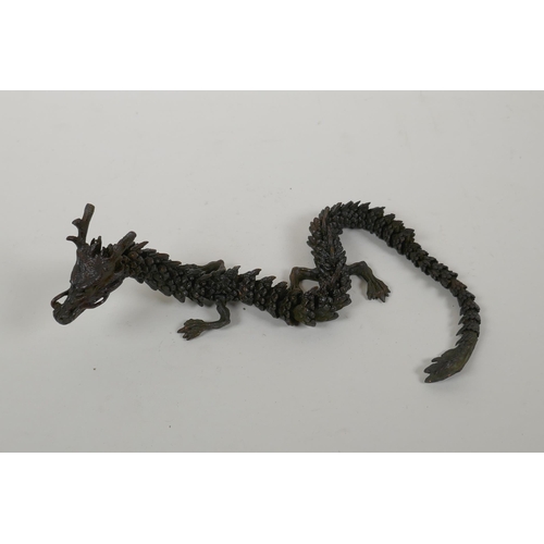 48 - A Japanese Jizai style bronzed metal okimono dragon with articulated parts, 38cm long