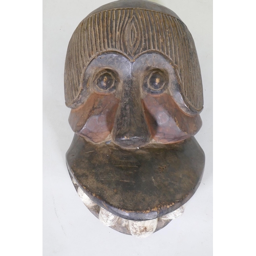 49 - An African tribal carved and painted wood mask in the form of a monkey, 30cm long