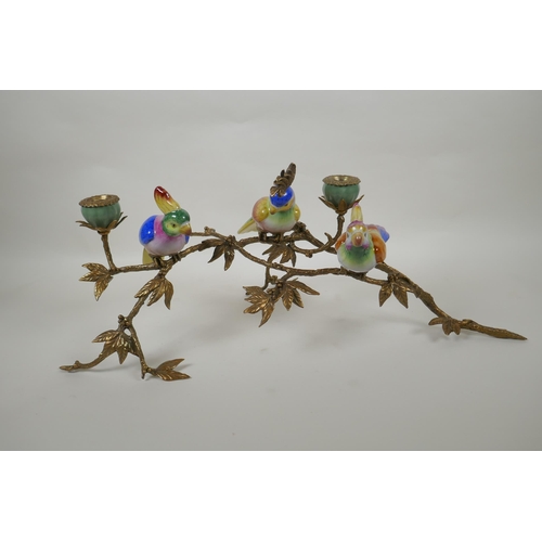 56 - A polychrome porcelain and gilt metal candelabrum in the form of cockatoos perched on a branch, 56cm... 