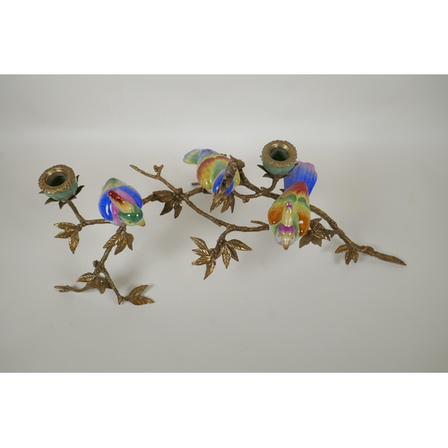 56 - A polychrome porcelain and gilt metal candelabrum in the form of cockatoos perched on a branch, 56cm... 