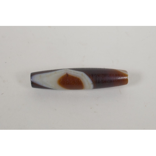 611 - A vintage banded agate dzi bead, 6cm long