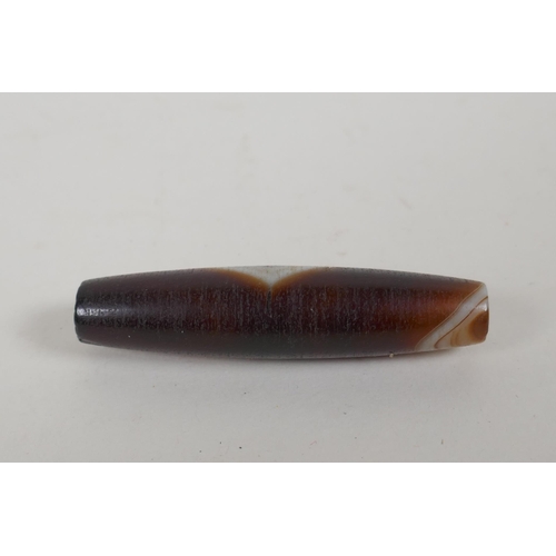 611 - A vintage banded agate dzi bead, 6cm long