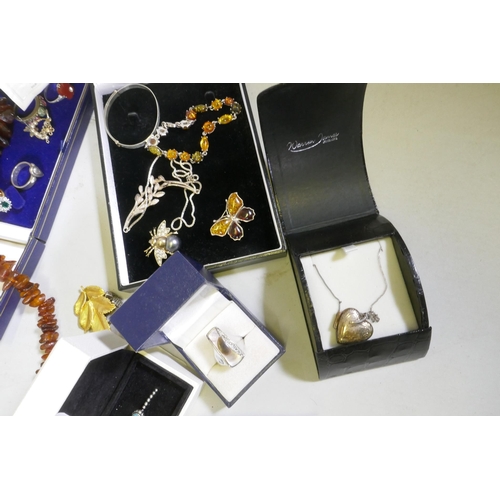 612 - A quantity of costume jewellery including silver, amber, hand painted bangles etc