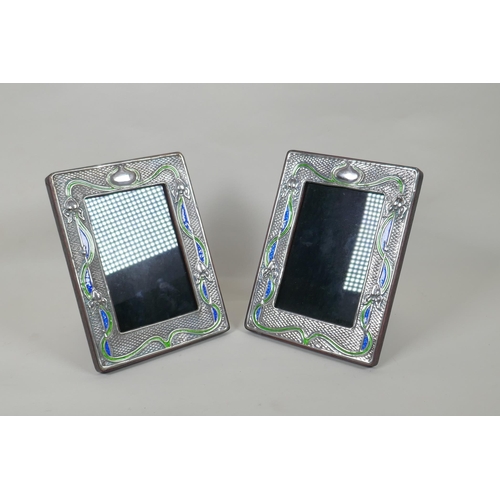 618 - A pair of sterling silver and enamel Art Nouveau style photo frames, 9 x 14cm aperture