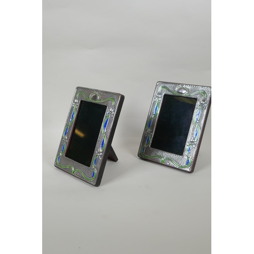 618 - A pair of sterling silver and enamel Art Nouveau style photo frames, 9 x 14cm aperture