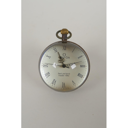 626 - A brass bound glass ball clock, 6cm diameter