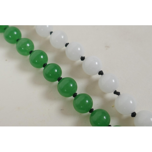 627 - An apple green jade bead necklace, and a similar white jade bead necklace, longest 70cm