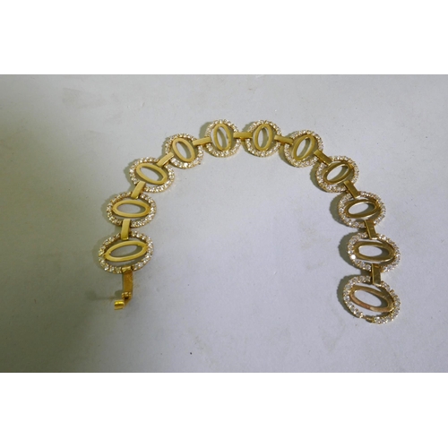 630 - An 18ct Arab gold link bracelet set with white crystals, 18cm long