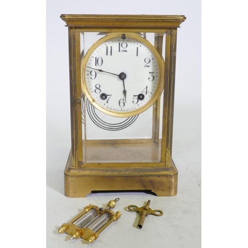 633 - A C19th/C20th brass four glass mantel clock, the porcelain dial with Arabic numerals, inscribed Anso... 