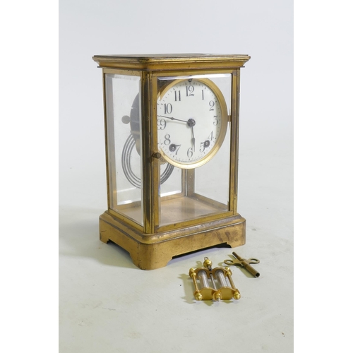 633 - A C19th/C20th brass four glass mantel clock, the porcelain dial with Arabic numerals, inscribed Anso... 