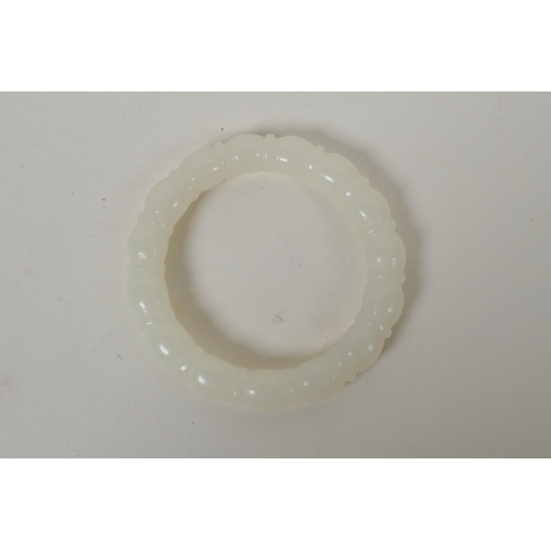 635 - A carved white hardstone bangle, 7.5cm diameter