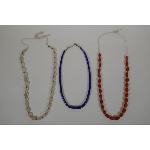 638 - A graduated lapis bead necklace, a string of graduated agate beads and a string of graduated crystal... 