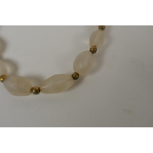 638 - A graduated lapis bead necklace, a string of graduated agate beads and a string of graduated crystal... 