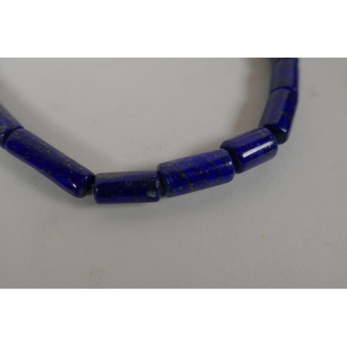 638 - A graduated lapis bead necklace, a string of graduated agate beads and a string of graduated crystal... 