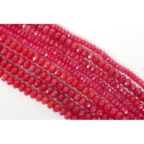 640 - Nine bead strings of faceted ruby coloured hardstone, assorted sized strands, 39cm long