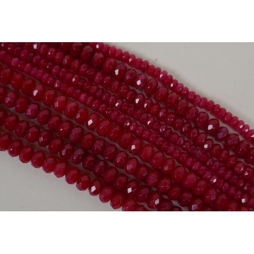 640 - Nine bead strings of faceted ruby coloured hardstone, assorted sized strands, 39cm long