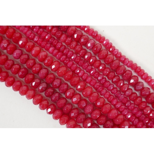 640 - Nine bead strings of faceted ruby coloured hardstone, assorted sized strands, 39cm long