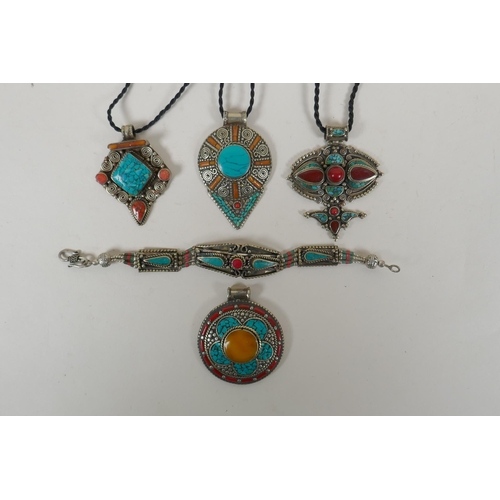 643 - A Tibetan white metal bracelet set with turquoise and coral shards, together with four similar penda... 