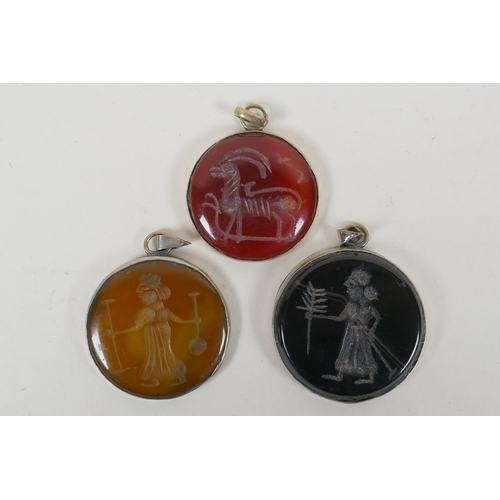 645 - Three Persian white metal pendants set with engraved figural agate intaglio stones, largest 4.5cm