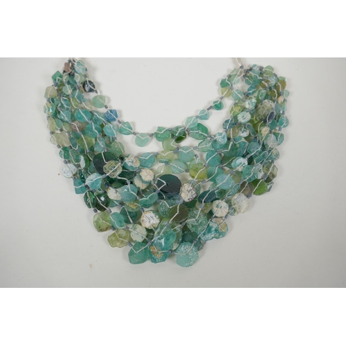 649 - An early multi strand glass bead necklace, possibly Roman, 76cm long