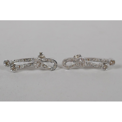 653 - A pair of Iranian white gold and diamond set earrings, indistinctly marked, gold untested, 5.3g gros... 