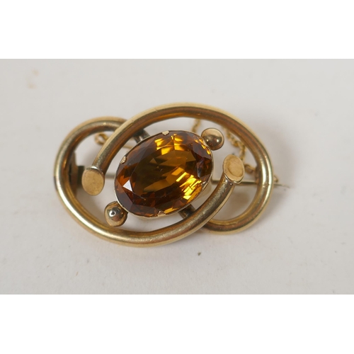 661 - An antique yellow metal brooch set with a large citrine stone, 11g groos