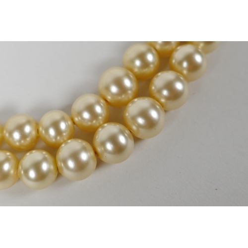 665 - A vintage graduated faux pearl twin strand necklace, 38cm long