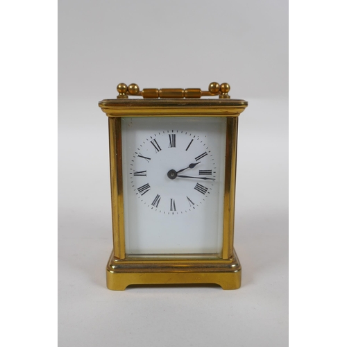 670 - A brass cased carriage clock, the enamel dial with Roman numerals, 8 x 6cm, 11cm high