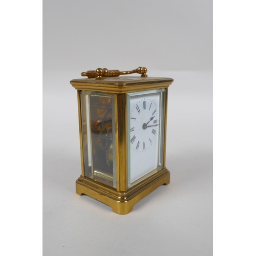 670 - A brass cased carriage clock, the enamel dial with Roman numerals, 8 x 6cm, 11cm high