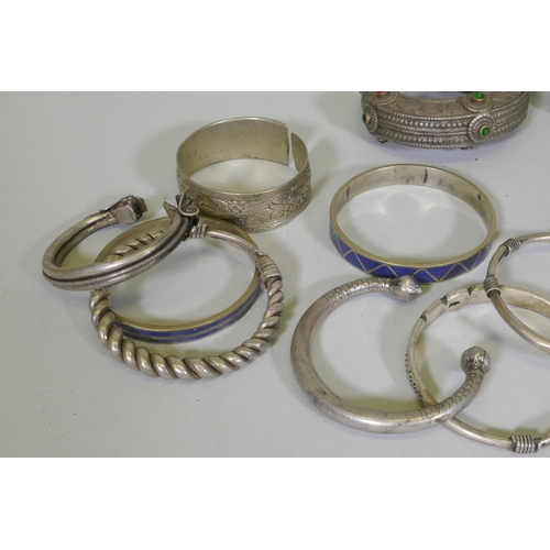 674 - A collection of Afghan white metal bangles, set with paste stones, bidri style decoration, a Chinese... 