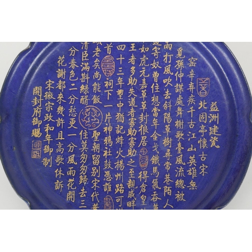 77 - A Chinese deep blue ground charger with lobed rim, decorated with chased and gilt character inscript... 