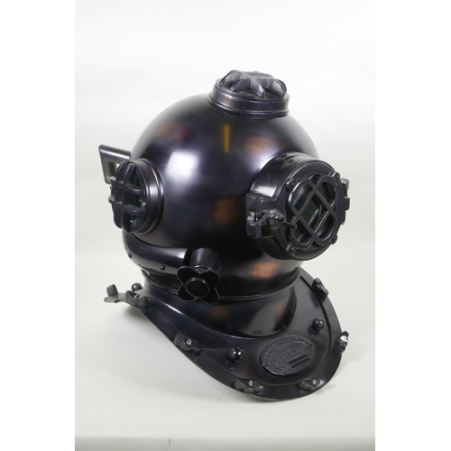 79 - A decorative antiqued copper and brass 'US Naval Diving Helmet', 42cm high