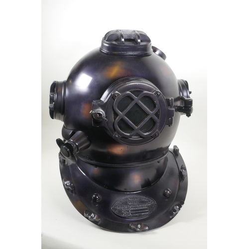 79 - A decorative antiqued copper and brass 'US Naval Diving Helmet', 42cm high