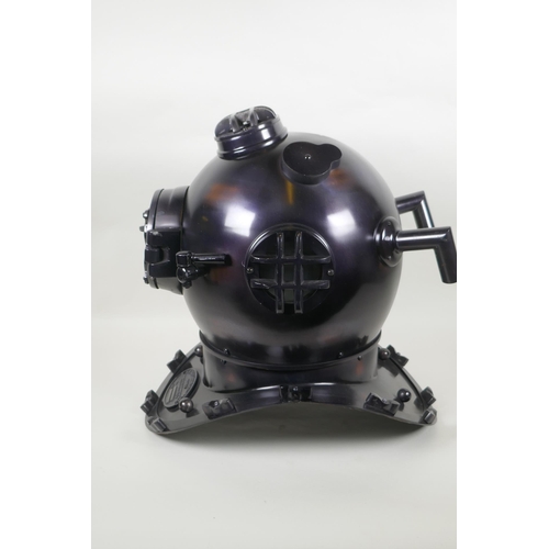 79 - A decorative antiqued copper and brass 'US Naval Diving Helmet', 42cm high