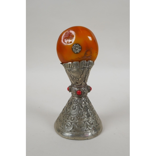 82 - A Tibetan white metal temple seal set with a faux amber rondel, 16cm high