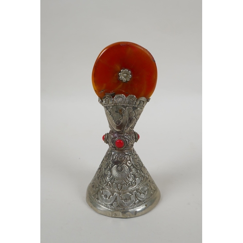 82 - A Tibetan white metal temple seal set with a faux amber rondel, 16cm high