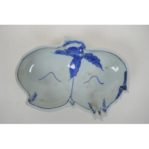 83 - A Japanese Meiji period blue and white porcelain sauce bowl in the form of peaches, and another in t... 