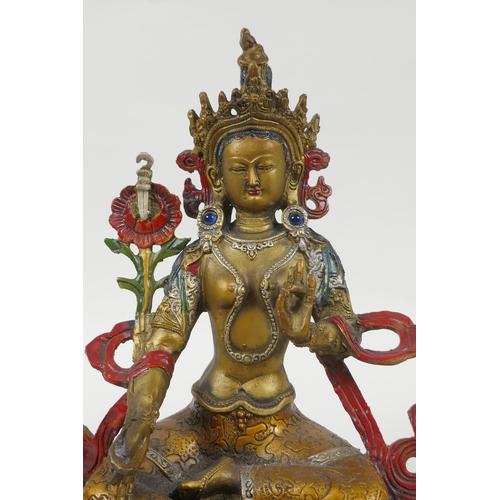 90 - A Tibetan gilt and cold painted metal figure of the goddess Green Tara, 22cm high