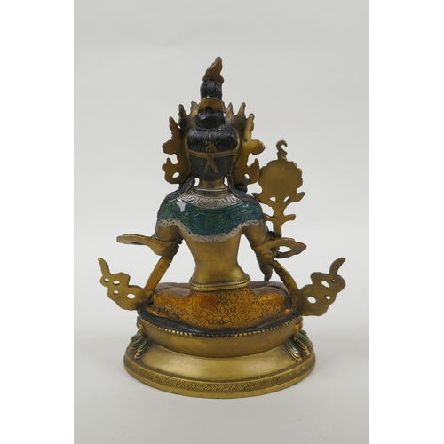 90 - A Tibetan gilt and cold painted metal figure of the goddess Green Tara, 22cm high