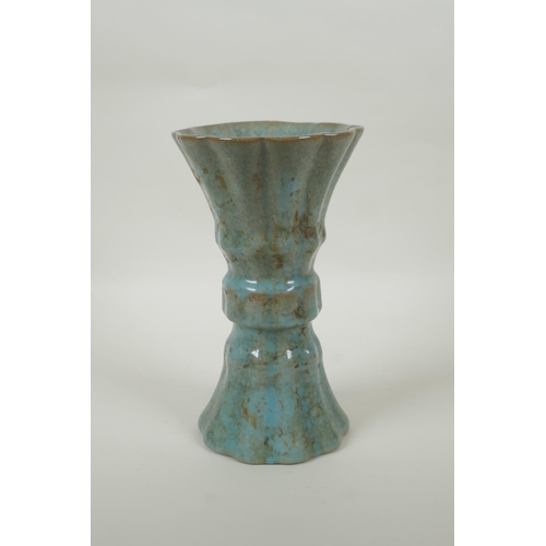 91 - A Chinese celadon crackle glaze gu shape vase of ribbed form, 23cm high