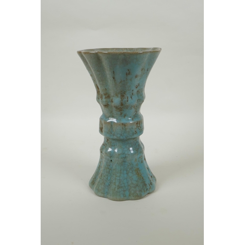 91 - A Chinese celadon crackle glaze gu shape vase of ribbed form, 23cm high