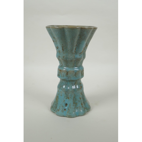 91 - A Chinese celadon crackle glaze gu shape vase of ribbed form, 23cm high