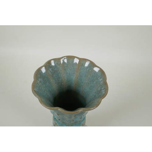 91 - A Chinese celadon crackle glaze gu shape vase of ribbed form, 23cm high