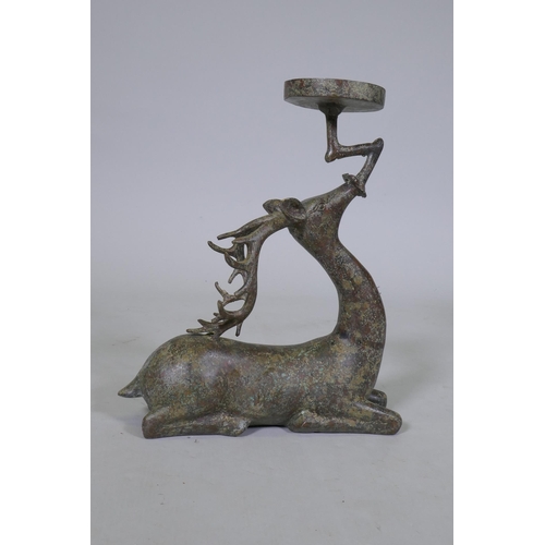 94 - An Eastern patinated bronze censer in the form of a deer, 33cm high