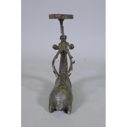 94 - An Eastern patinated bronze censer in the form of a deer, 33cm high