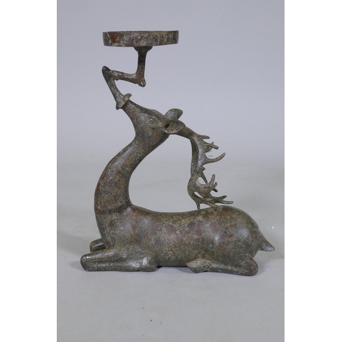 94 - An Eastern patinated bronze censer in the form of a deer, 33cm high